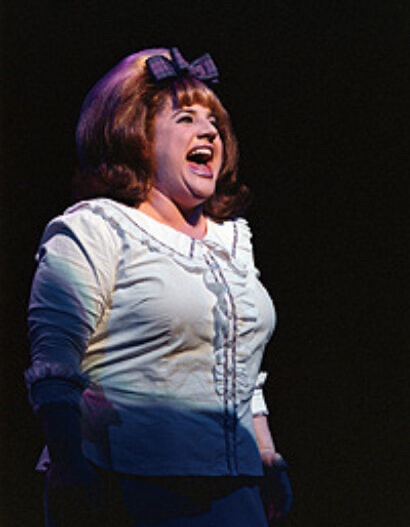 Marissa Jaret Winokur singing on stage as Tracy Turnblad in Hairspray
